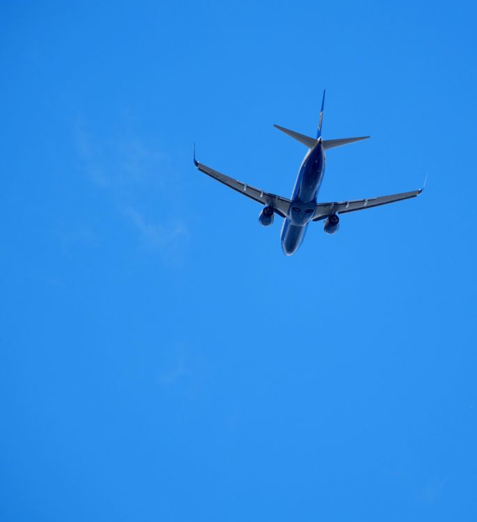 Airplane Flying High in Clear Blue Sky · Free Stock Photo