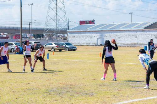 Free Group of teenagers playing flag football outdoors on a sunny day in Toluca, Mexico. Stock Photo