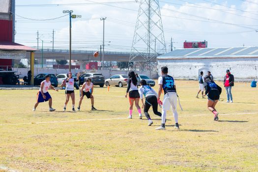 A lively youth flag football game in Toluca, showcasing teamwork and sports spirit.