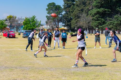 Free Young athletes engage in an exciting game of flag football outdoors in Toluca, Mexico. Stock Photo