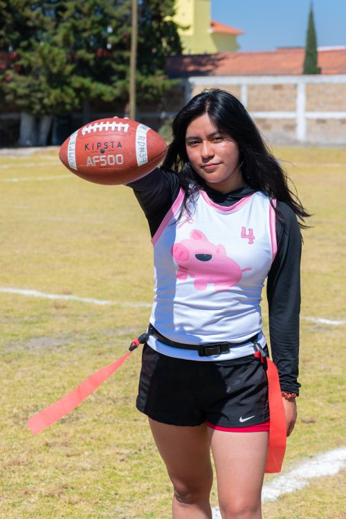 Free A young female player holding a football in a game setting in Toluca de Lerdo. Stock Photo