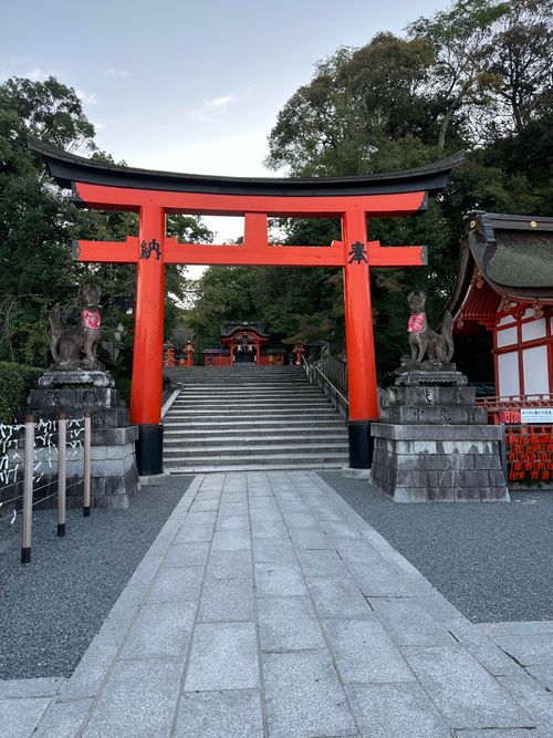 Free The iconic red Torii gate at Fushimi Inari Taisha, Kyoto, Japan. Tranquil atmosphere with lush greenery. Stock Photo