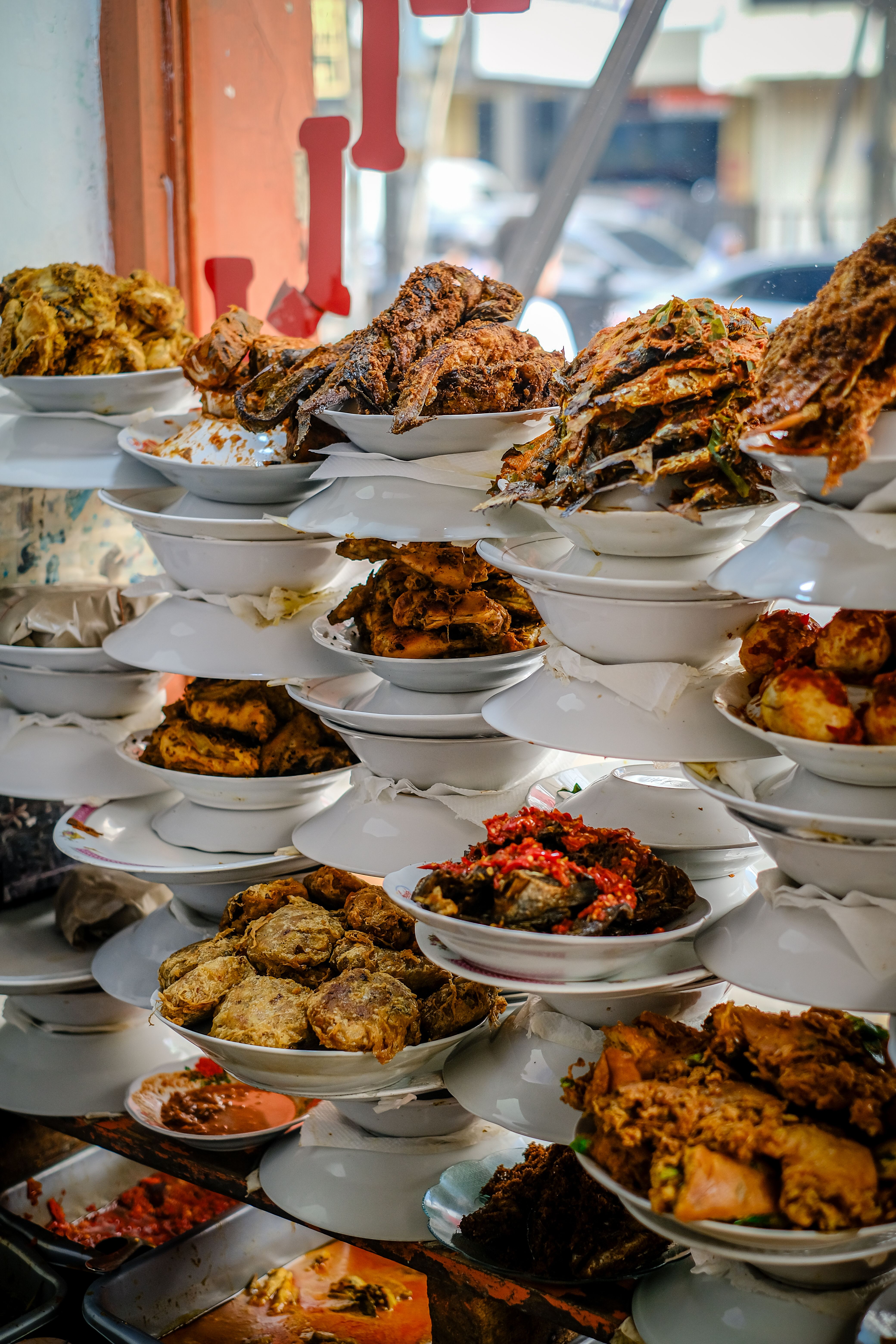 Sumptuous Padang dishes stacked in a Jakarta eatery, showcasing diverse Indonesian flavors.
