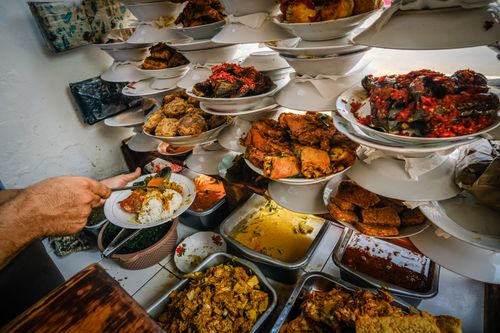 Free A vibrant array of traditional Padang dishes served buffet style at a local restaurant in Jakarta. Stock Photo
