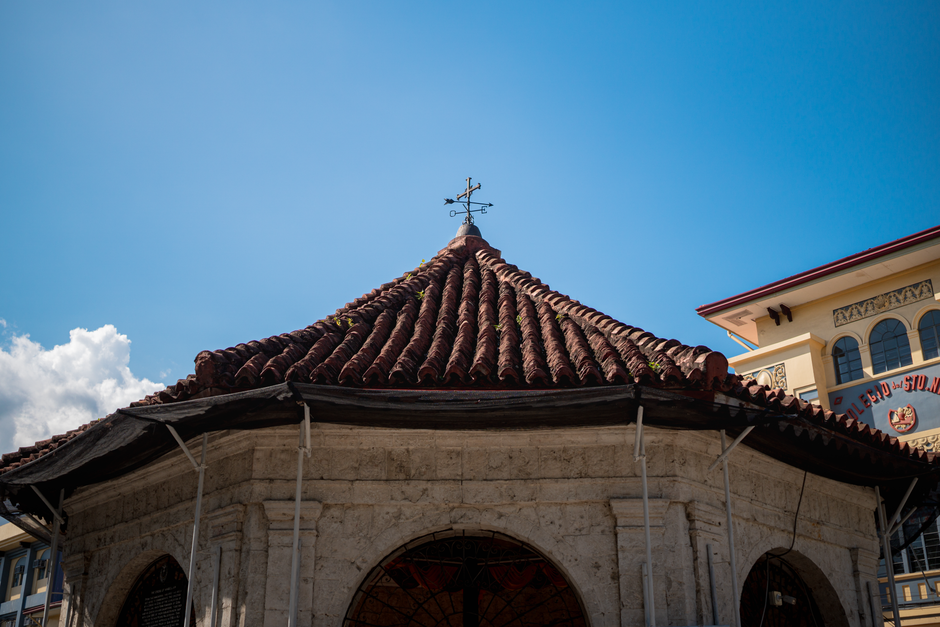 Historic Magellan's Cross Pavilion in Cebu City under a clear blue sky.