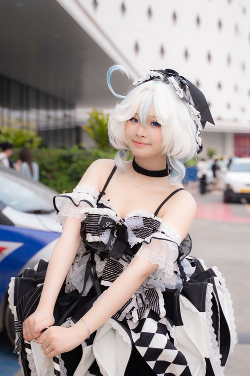 Free A cosplayer poses in a stylish black and white outfit outdoors during the day. Stock Photo