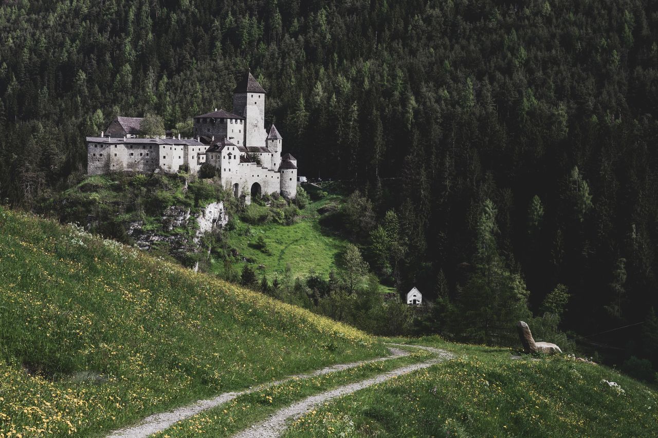stunning view of a medieval castle surrounded by lush greenery in a se