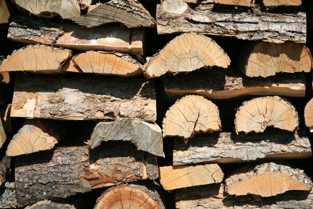 Close-up of a stacked cord of split firewood showing natural grain and rings
