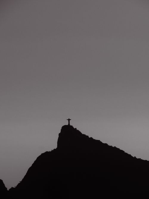 Free Dramatic silhouette of Christ the Redeemer atop Corcovado Mountain, Rio de Janeiro. Stock Photo