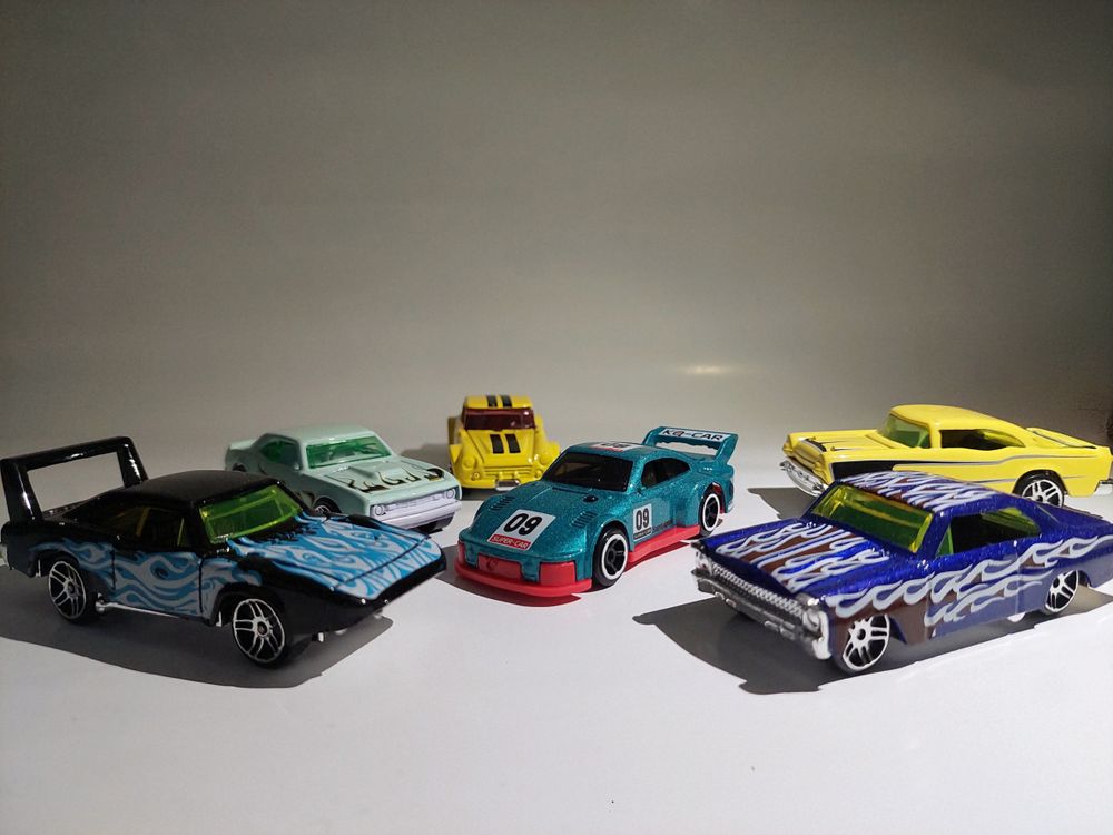 Free Array of vibrant toy race cars with unique designs, showcasing different models and styles. Stock Photo