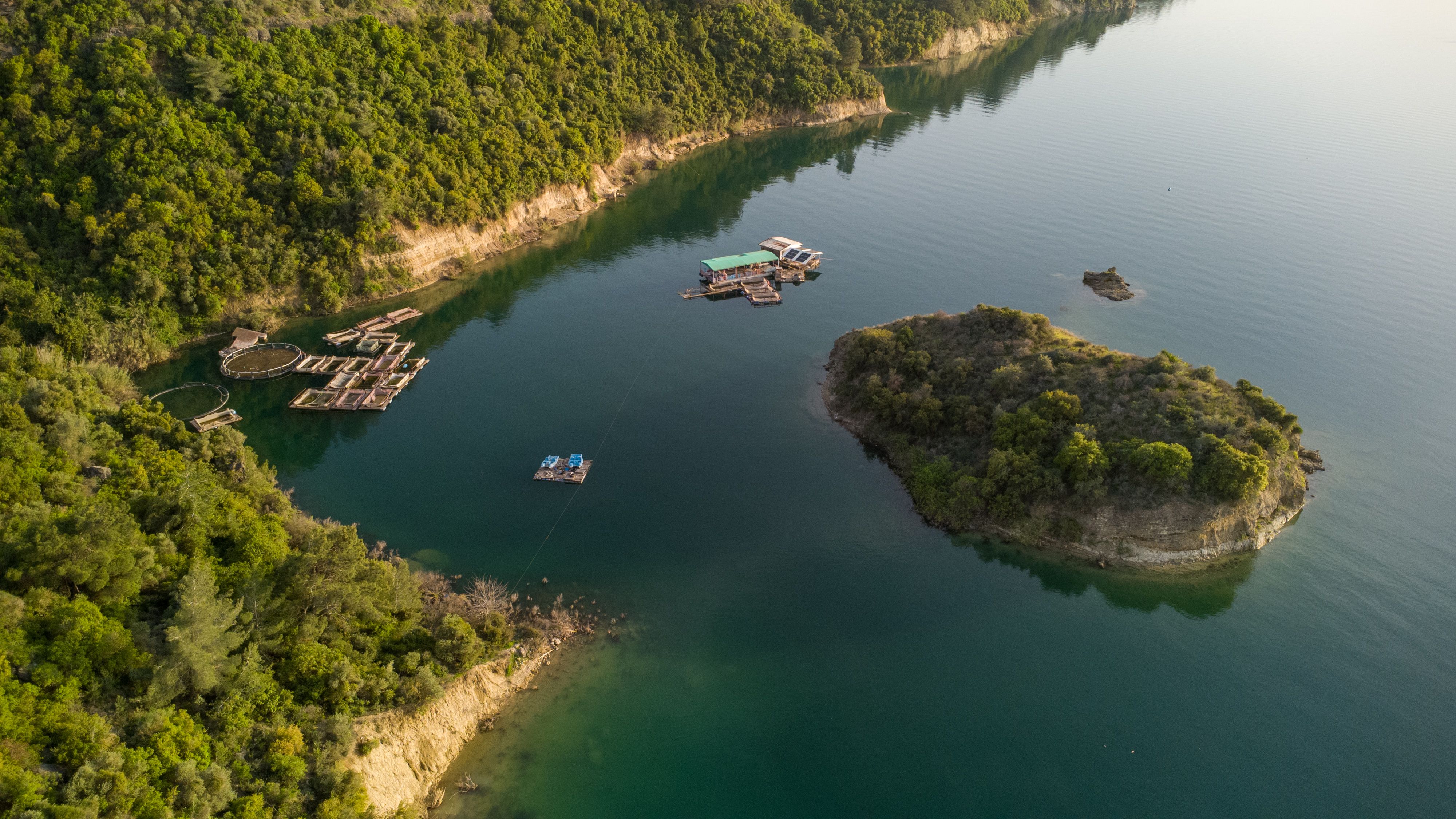 Aerial View of a Serene Lake with Floating Platforms · Free Stock Photo