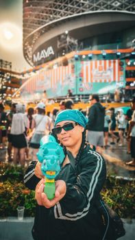 Person enjoying a vibrant water festival at Maya Mall in Chiang Mai.