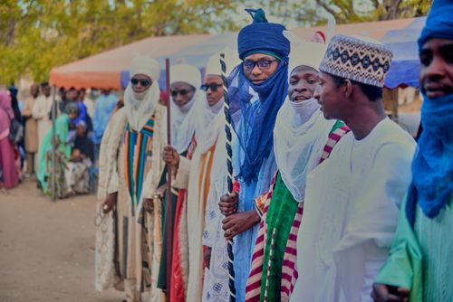 Free Men in colorful traditional robes at an African festival, engaging with the community. Stock Photo