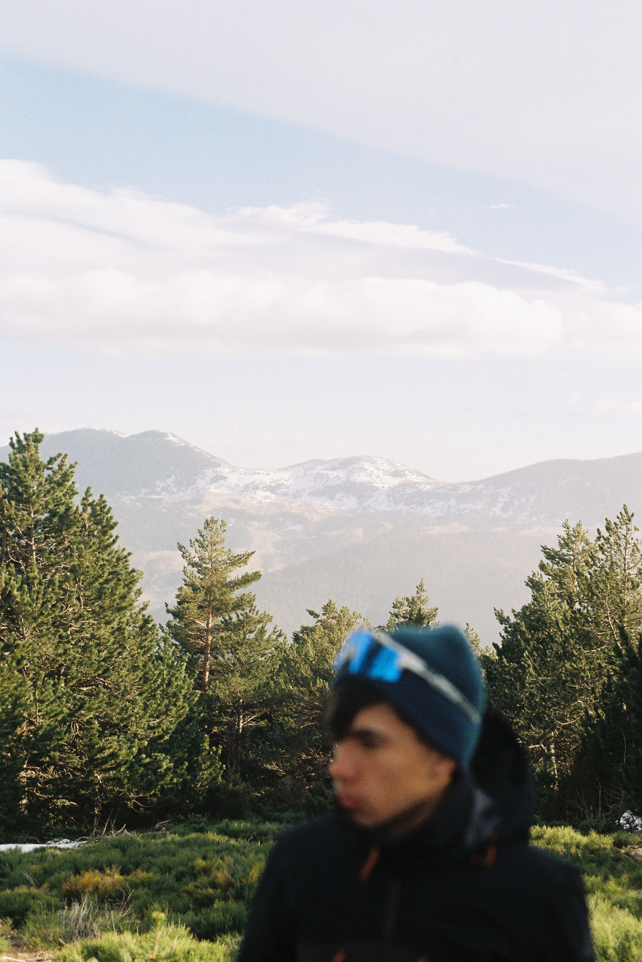 Mountains and forest landscape in Núria, Catalonia with a blurred figure.