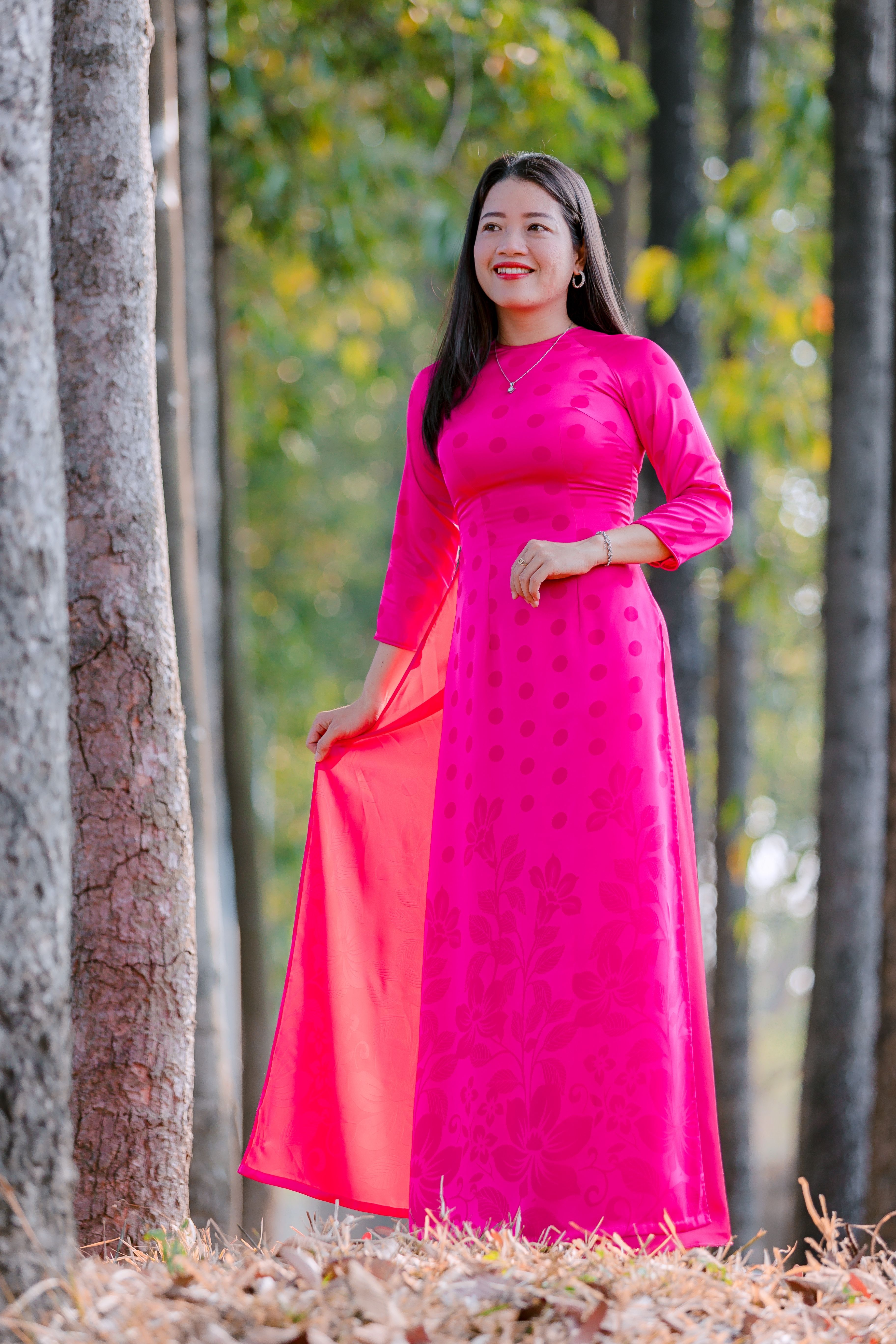 Woman in Pink Dress Posing Outdoors Among Trees · Free Stock Photo