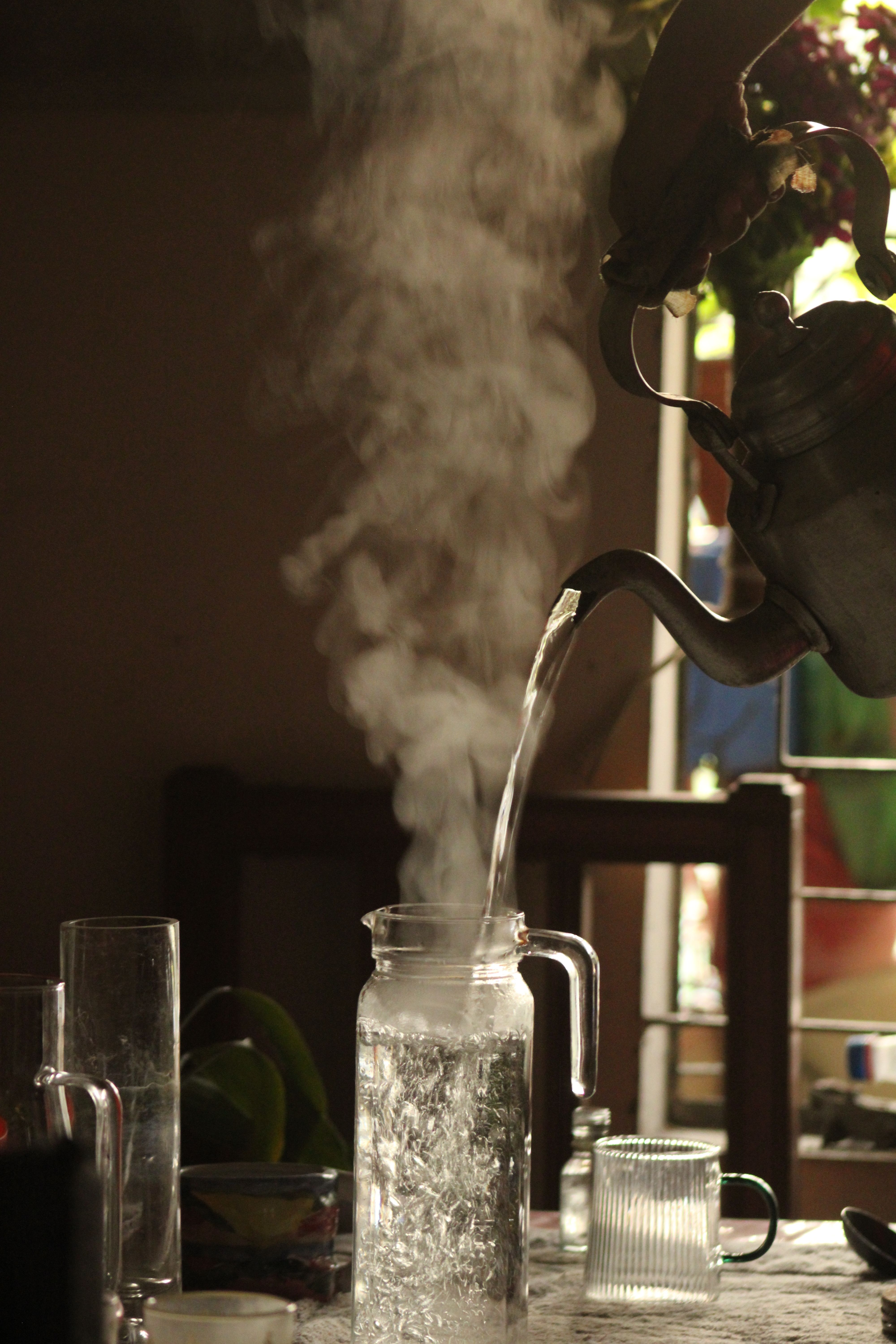 Pouring freshly prepared cold-brew saunf water into a glass.
