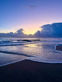 Serene sunrise over the waves at Gold Coast, Australia, showcasing calm sea and vivid sky.