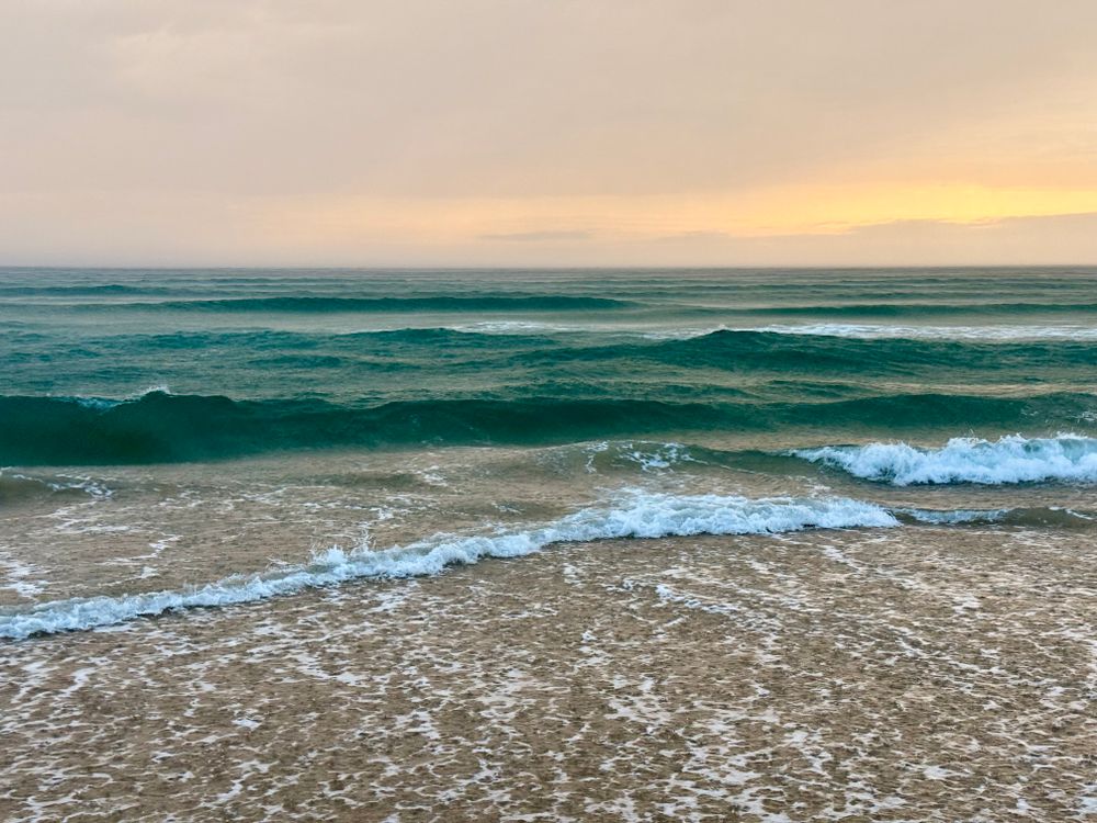 Peaceful Beach Waves at Sunset · Free Stock Photo