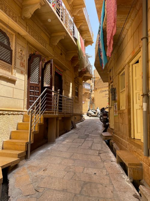 Free A vibrant image of the narrow streets in Jaisalmer, showcasing stunning golden architecture under a bright sky. Stock Photo