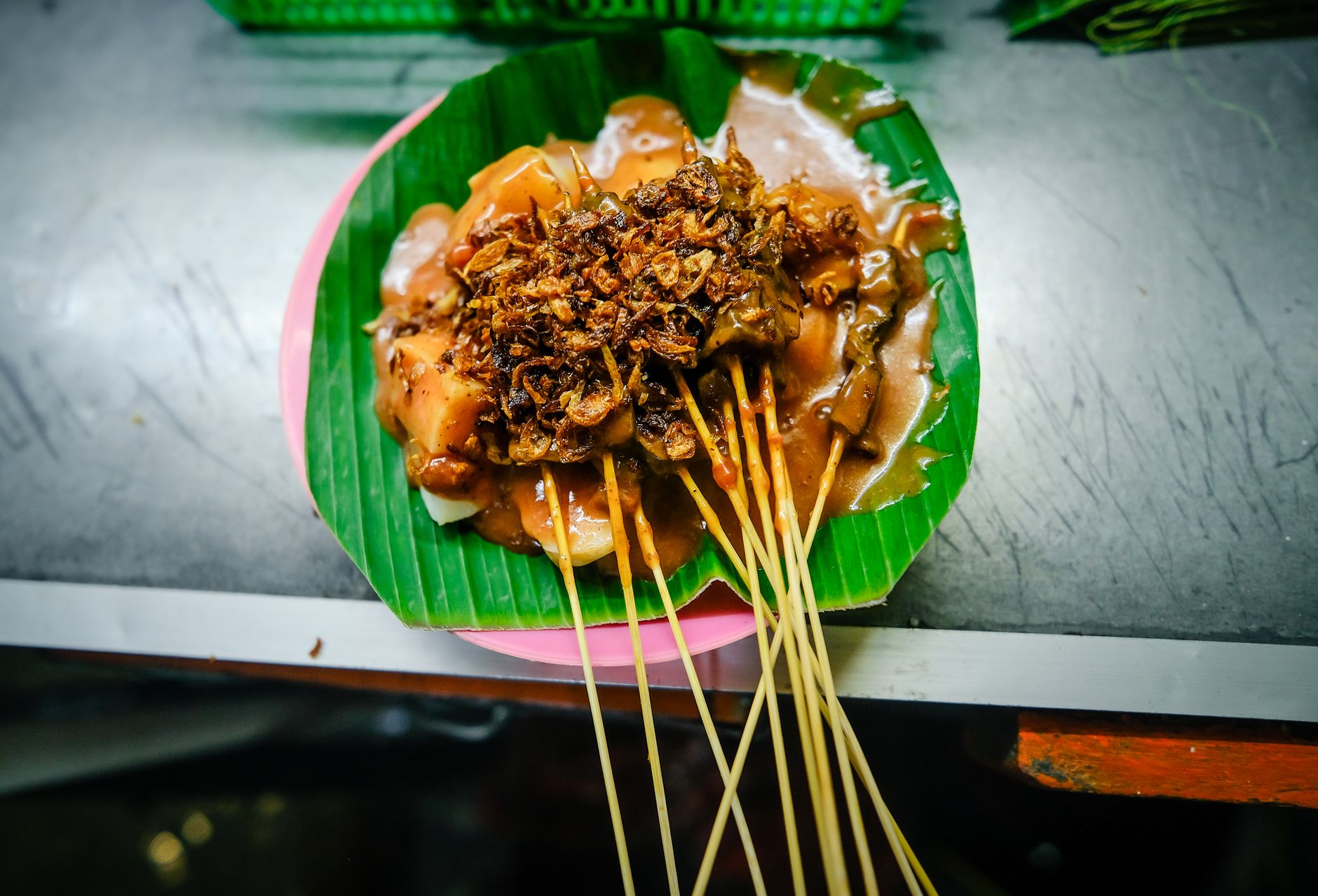 Delicious Sate Padang served on banana leaf, showcasing authentic Indonesian street food.