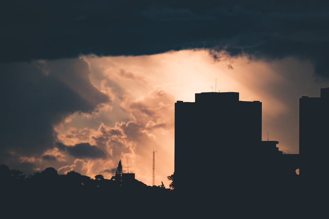 Silhouette of Building Under Cloudy Sky during Sunset
