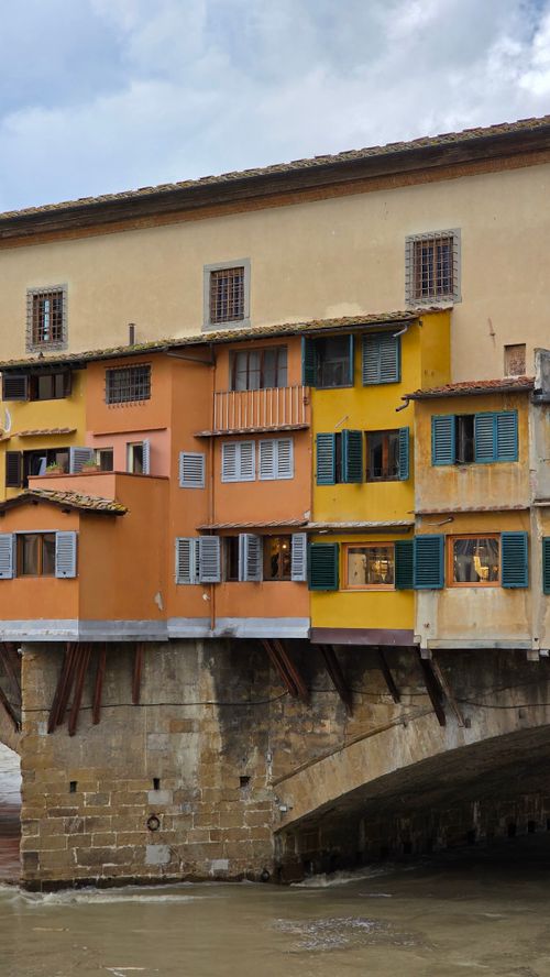 Free Vibrant buildings on the historic Ponte Vecchio bridge in Florence, Italy, showcasing Tuscan architecture. Stock Photo