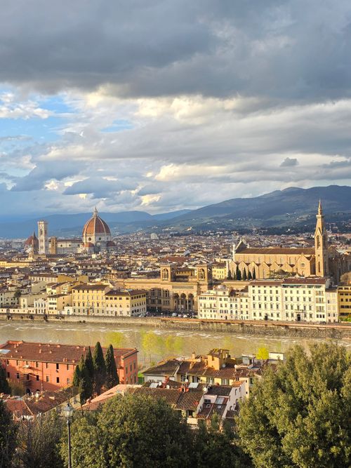 Free A breathtaking view of Florence with iconic landmarks under a dramatic sky. Stock Photo