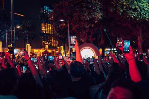 Free A vibrant crowd in Taguig capturing nightlife with smartphones. Perfect for social media and urban lifestyle themes. Stock Photo