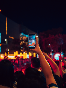 Lively night street festival in Taguig captured through a smartphone, showcasing vibrant celebrations and urban energy.