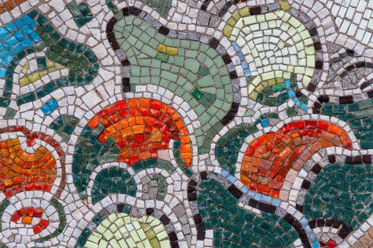 Vibrant mosaic artwork featuring an abstract geometric design in multicolored tiles.