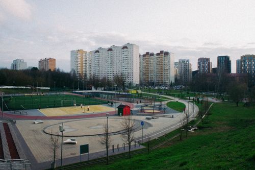 Free An aerial view of an urban park landscape with sports facilities and high-rise apartments. Stock Photo