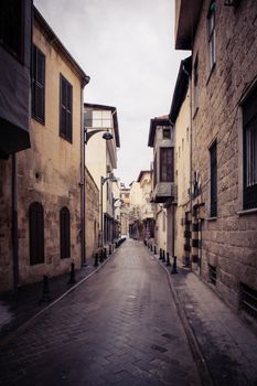 Charming narrow alley in the historic district of Gaziantep, Türkiye with old stone houses.
