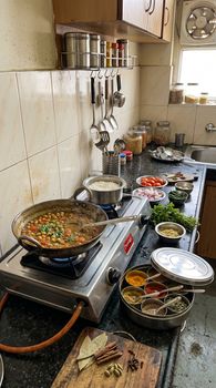 Traditional Indian kitchen with chole masala and spices on display, capturing authentic home cooking in India.