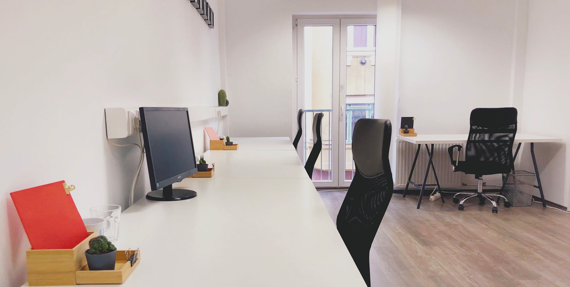 Bright and modern coworking office space in Budapest, showcasing minimalist design and contemporary furniture.