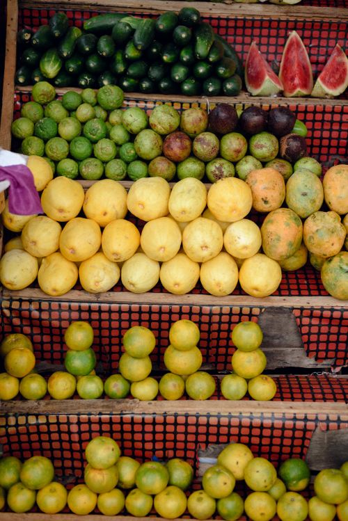 Free Vibrant display of various tropical fruits arranged on market stall shelves in Jos, Nigeria. Stock Photo