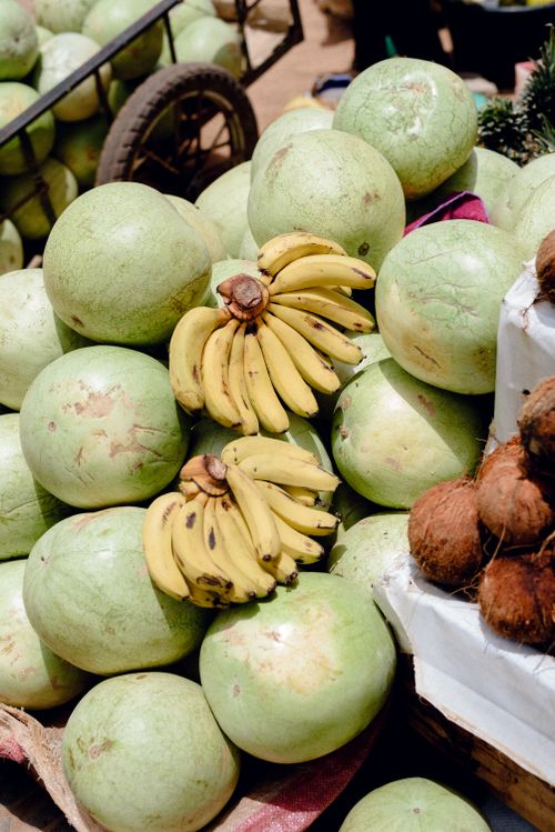 Free A vibrant display of tropical fruits including watermelons, bananas, and coconuts at a market in Jos, Nigeria. Stock Photo