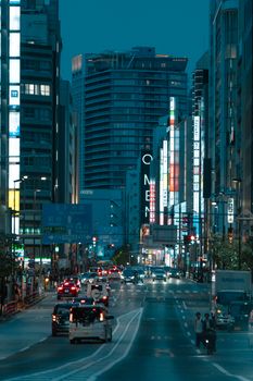 Tokyo city street bustling with traffic and vibrant neon lights during twilight.. pexels, tokyo, city