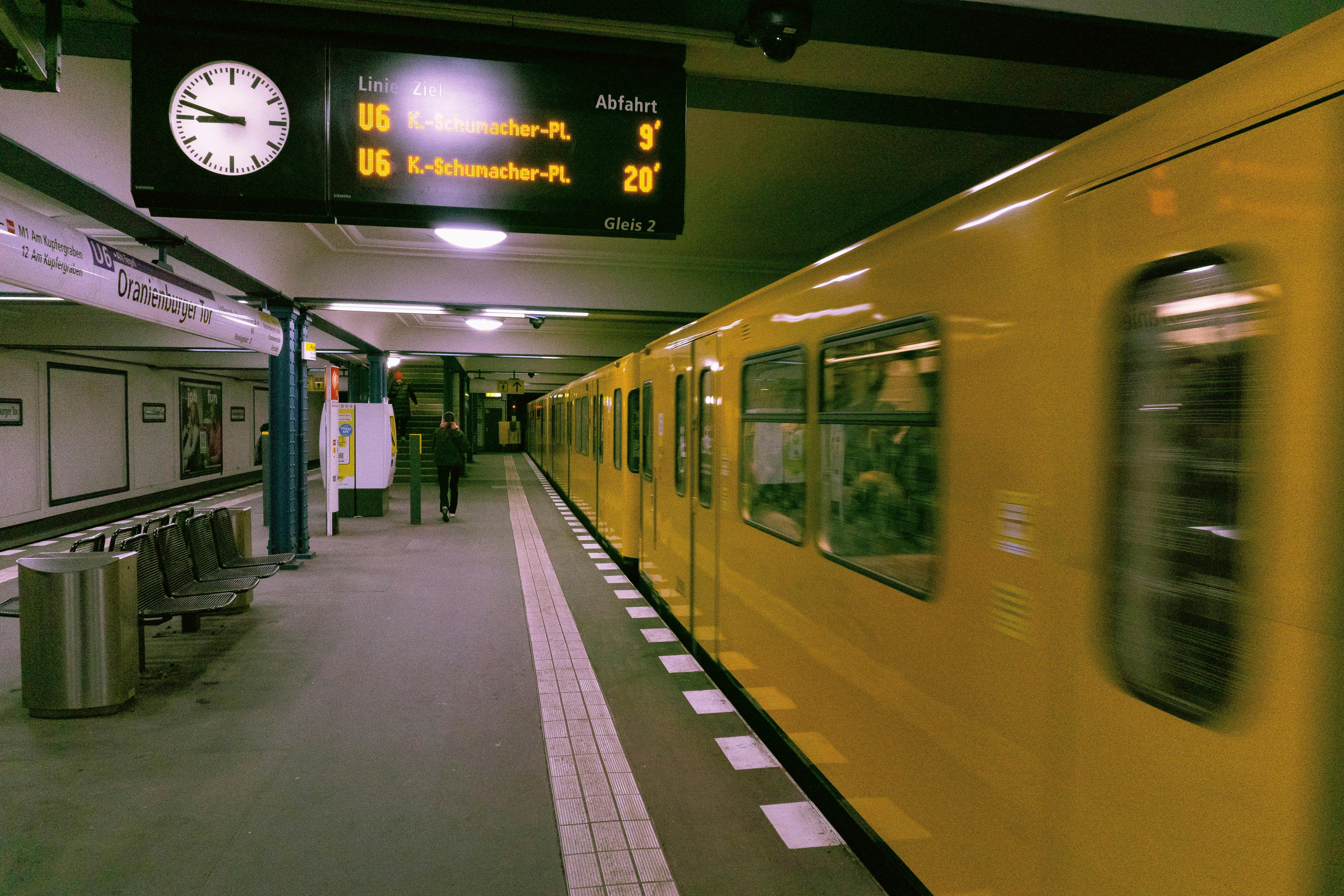 Yellow subway train in motion at Oranienburger Tor station, Berlin, Germany.