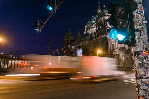 Free Blurred night traffic passing by the Berlin Cathedral, highlighting urban life in Berlin. Stock Photo