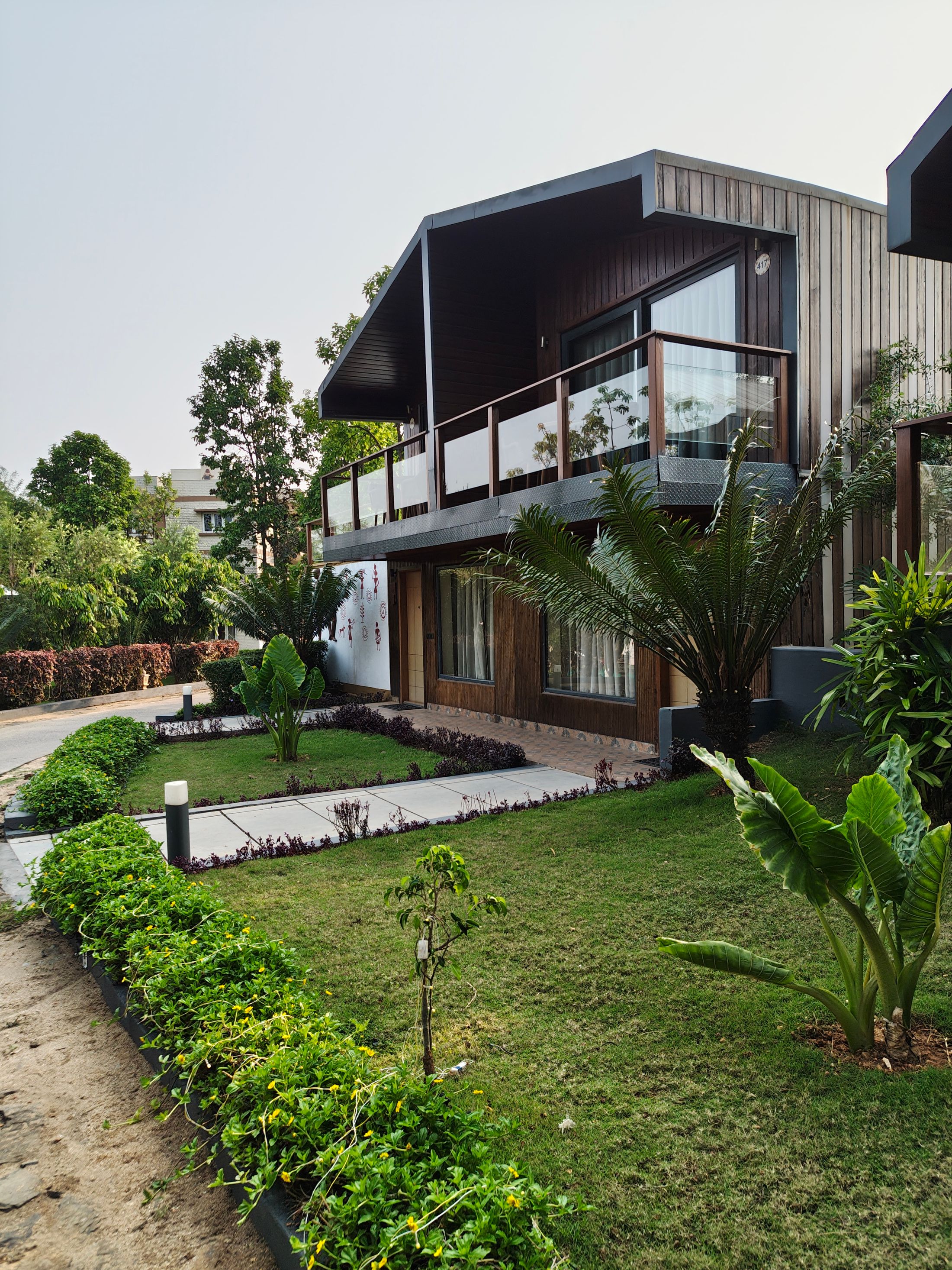 Two-storey house with a balcony and a garden