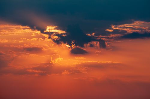 Free A breathtaking sunset with dramatic clouds and vibrant orange and blue hues. Stock Photo