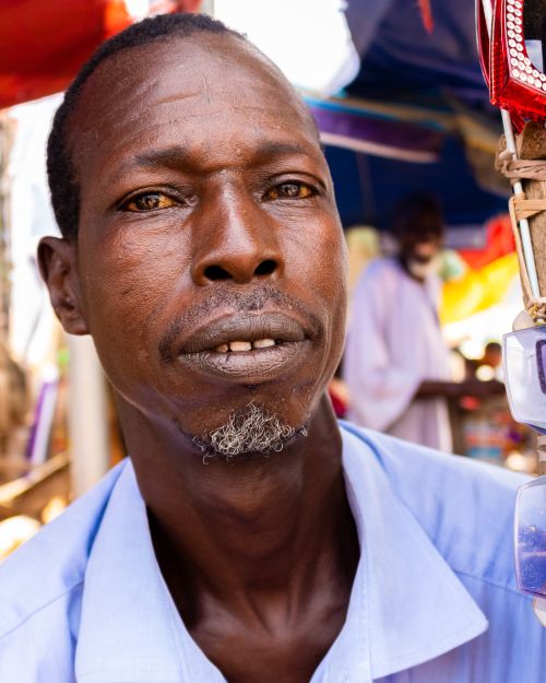 Free Close-up portrait of a vendor in a vibrant Ibadan market, Nigeria. Stock Photo