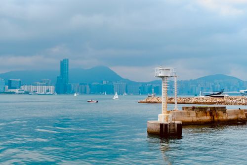 Free Explore the serene waterfront of Hong Kong Island with a view of sailboats and city skyline. Stock Photo