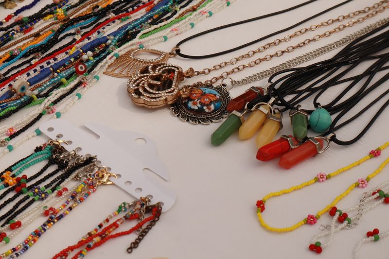 Variety of vibrant handmade beaded necklaces and pendants, reference style