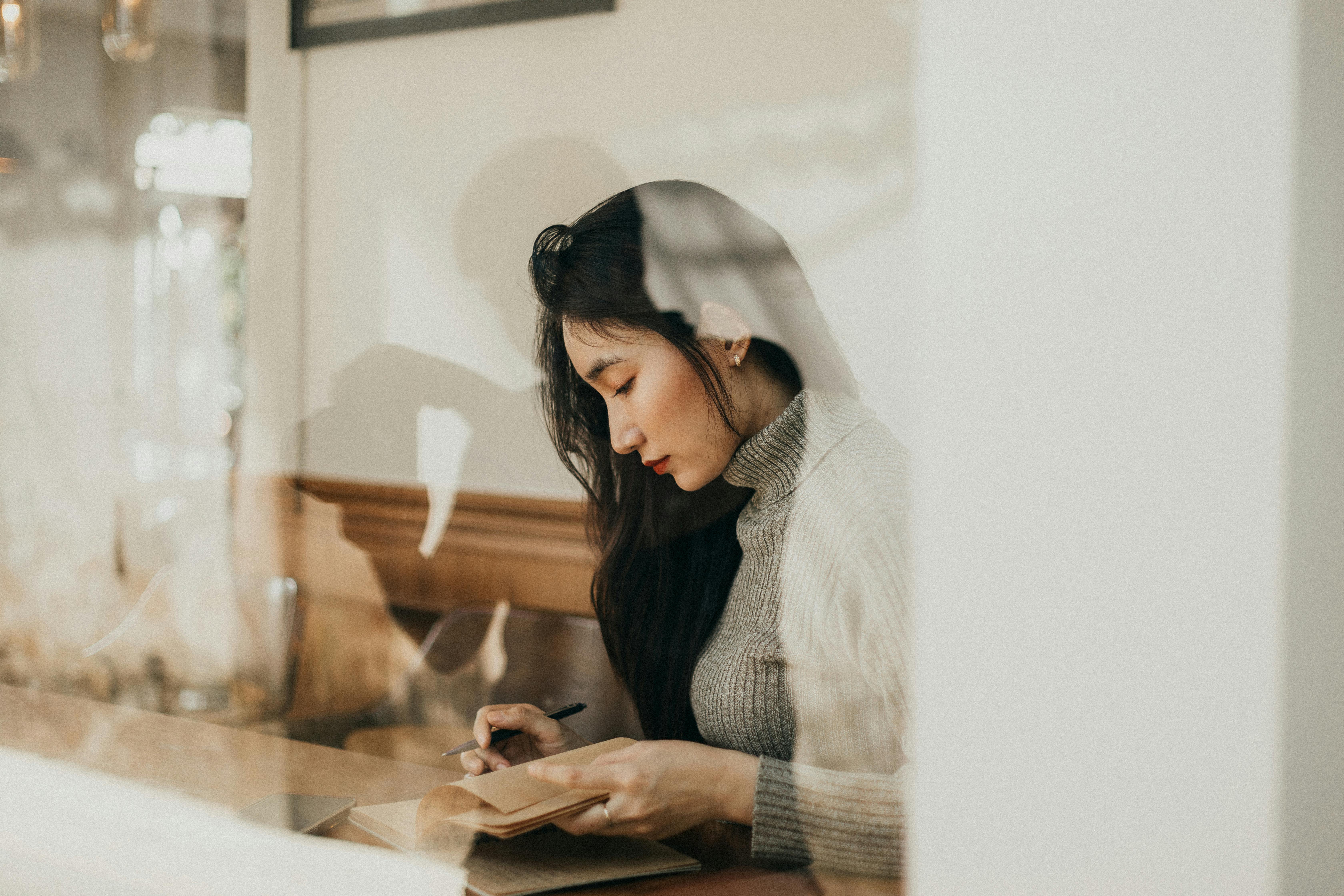 person sitting with laptop and coffee looking thoughtful