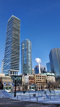 A clear winter day showcasing Toronto's modern skyscrapers against a blue sky.