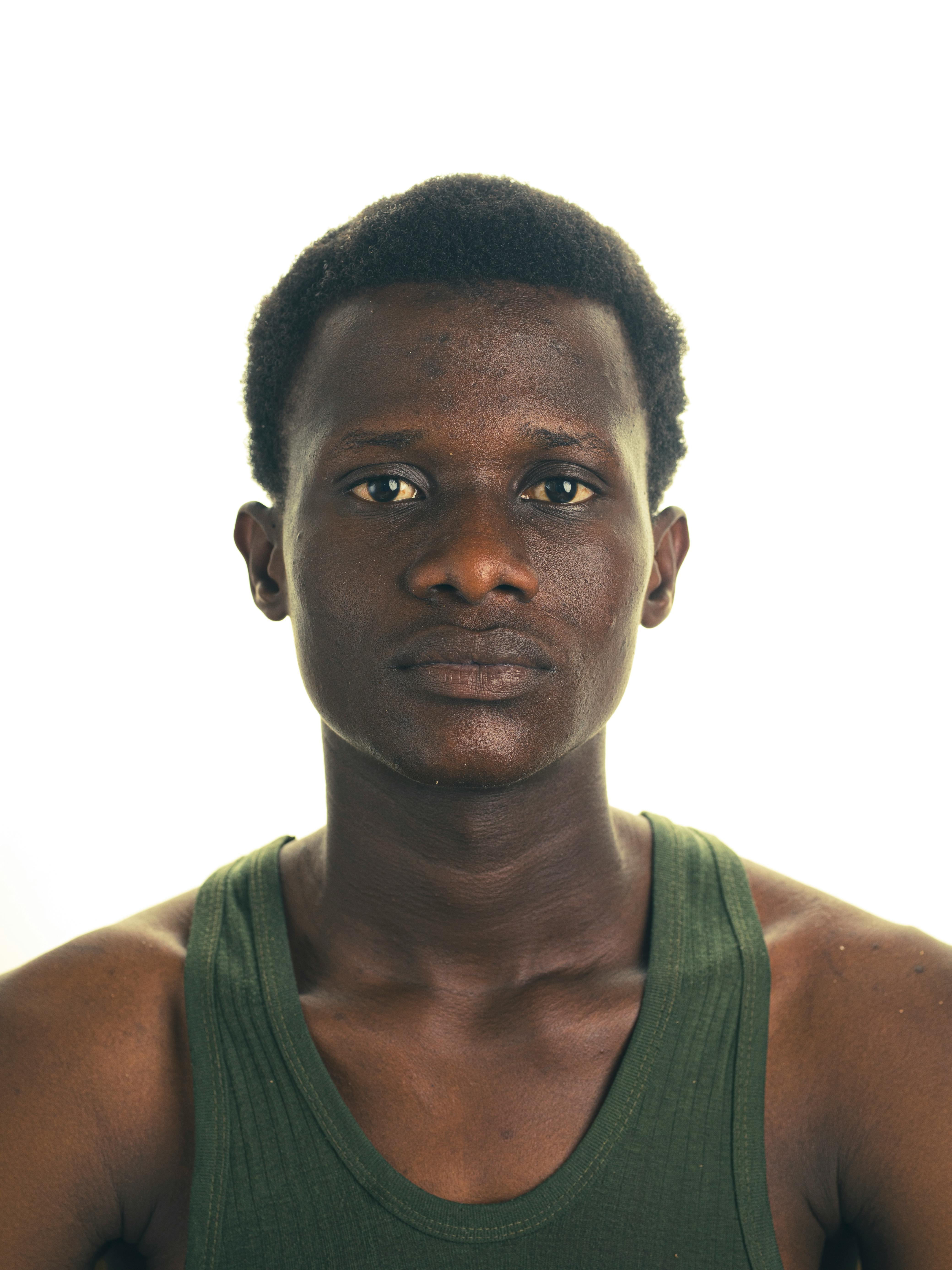 Studio portrait of a young adult in Kano, Nigeria wearing a green tank top.