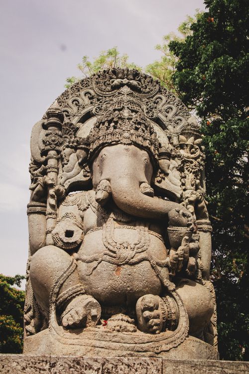 Free Historic stone statue of Lord Ganesha in a serene outdoor setting, showcasing intricate carvings. Stock Photo
