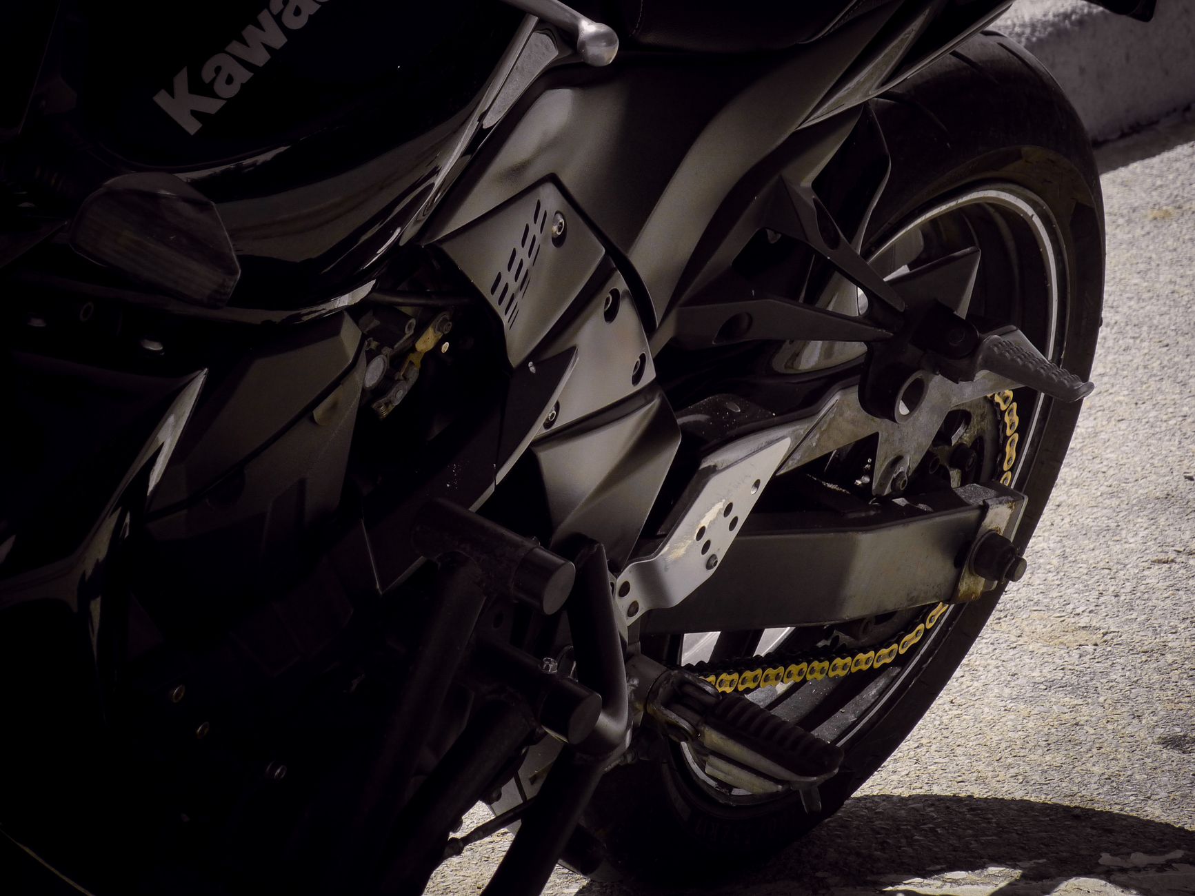 Motorcycle chain being cleaned and lubed