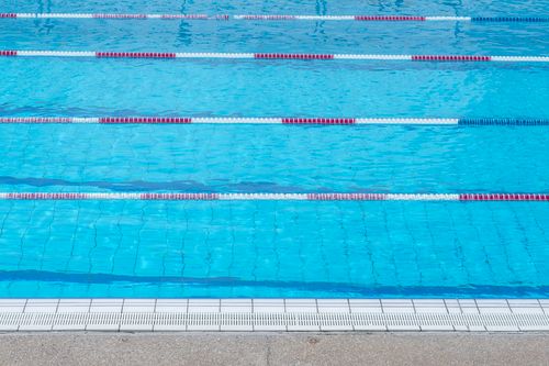Free Clear blue water in an outdoor swimming pool with marked swim lanes. Stock Photo